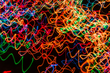 Abstract background with lights in blurred motion in the night or fireworks in new years eve
