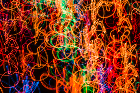 Abstract background with lights in blurred motion in the night or fireworks in new years eveの写真素材