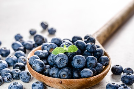 Wooden spoon with blueberries. Fresh berries isolated on white backgroundの写真素材