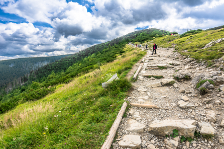 ZAKOPANE, POLAND - AUGUST 16, 2016: Group of hikers on hiking trail, trekking in Tatra Mountains, tourist travel conceptのeditorial素材