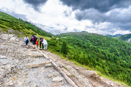 ZAKOPANE, POLAND - AUGUST 16, 2016: Group of hikers on mountain hiking trail, trekking in Tatra Mountains, Polandのeditorial素材