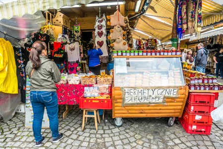 ZAKOPANE, POLAND - AUGUST 17, 2016: Street trading in the city center of Zakopane - sale of tourist souvenirs - people buying homemade regional product and handicraftのeditorial素材