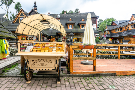 ZAKOPANE, POLAND - AUGUST 17, 2016: Street trading in the city center of Zakopane - sale of oscypek, traditional polish smoked cheese - street food and tourist attraction in the summer seasonのeditorial素材
