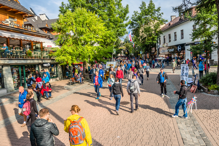 ZAKOPANE, POLAND - AUGUST 18, 2016: Crowd of people tourists in mountain resort Zakopane on the famous street Krupowki in summer season 2016のeditorial素材