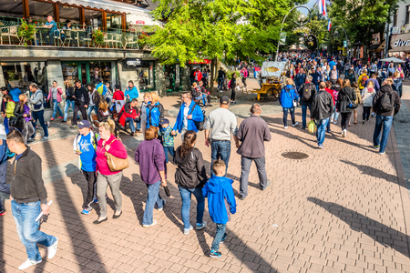 ZAKOPANE, POLAND - AUGUST 18, 2016: Crowd of people tourists in mountain resort Zakopane on the famous street Krupowki in summer season 2016のeditorial素材