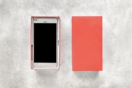 New mobile phone and box, gift smartphone with black screen and blank space for wishの写真素材