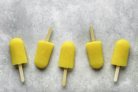Homemade with orange juice, ice lollies on sticks, top view flat layの写真素材