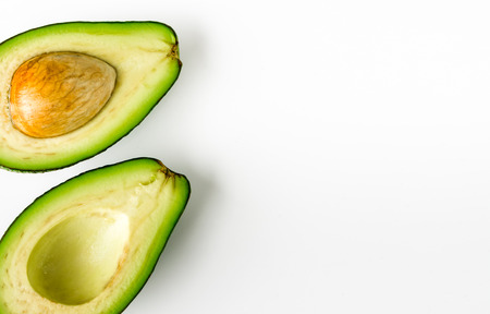 Halves of avocado isolated on white background, healthy food conceptの写真素材