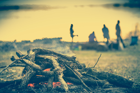 Group of people on camp with campfire, camping in natureの写真素材