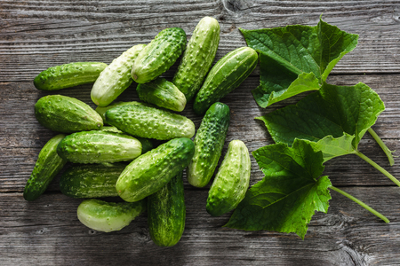 Fresh cucumbers on wooden table, vegetables on local farmer marketの写真素材