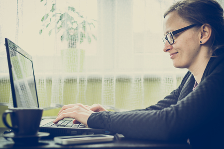 Smiling business woman using computer in work at homeの写真素材