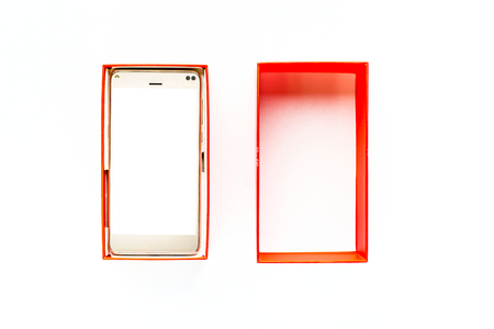 Gift box with smart phone, white screen, elegant mobile device, wireless communication conceptの写真素材