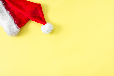Santa claus hat. Christmas pastel yellow background. Christmas banner with copy space for text.の写真素材