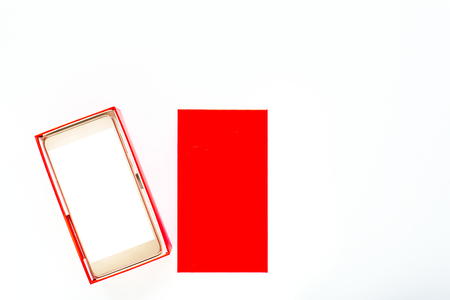 Box with modern smartphone with blank screen on white backgroundの写真素材
