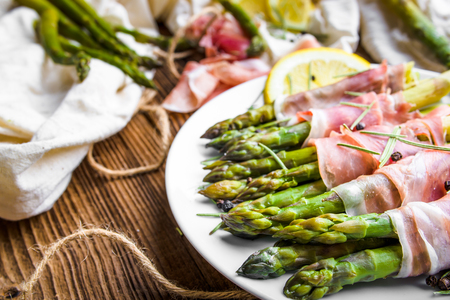 Appetizing italian food - cooked asparagus with meat - appetizer on plateの写真素材