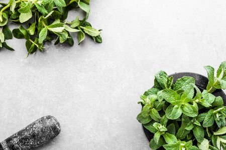 Green mint leaves or peppermint, fresh mint in mortar, top view