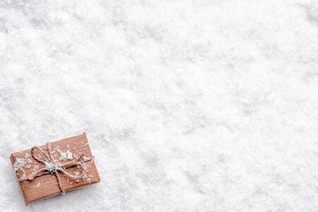 Christmas snow background with christmas gift, top view, flat layの写真素材