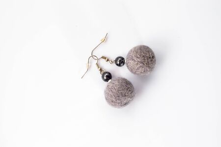 Felt earrings beads shaped. Handmade stylish felt jewelry made with gray felt beads isolated on a white background.の写真素材
