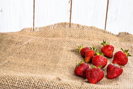 Fresh strawberries, ripe fruits on farmer market on rustic backgroundの写真素材