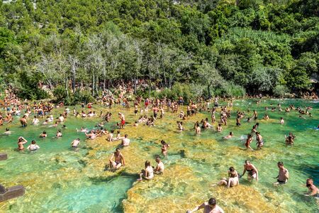 KRKA NATIONAL PARK, CROATIA - AUG 19, 2019: People swim in Krka River over Skradinski Buk in Croatia, Waterfall in Krka National Parkのeditorial素材