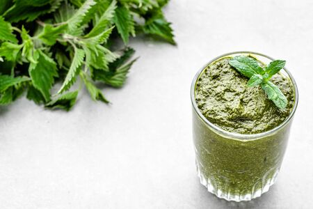 Glass of smoothie or green juice, detox drink with nettle leavesの写真素材