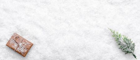 Christmas background, composition with snow, christmas gift and fir tree, top view with copy spaceの写真素材