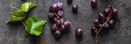 Freshly harvested grapes with vine leaf. Fresh red grape, top view.の写真素材
