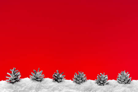 Christmas red background with snow and christmas decorationsの写真素材