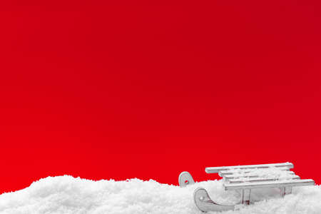Festive red Christmas background with snow and sled