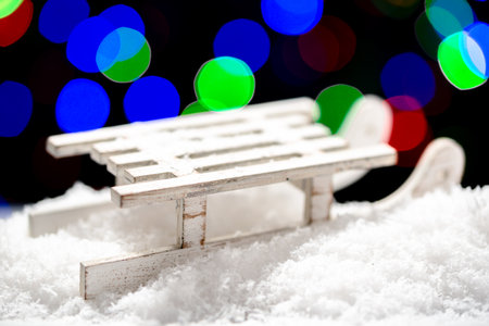 Christmas lights background with snow and sleighの写真素材