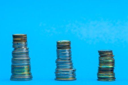 Money stacks. Coins descending in columns. Concept of recession and financial crisis.の写真素材