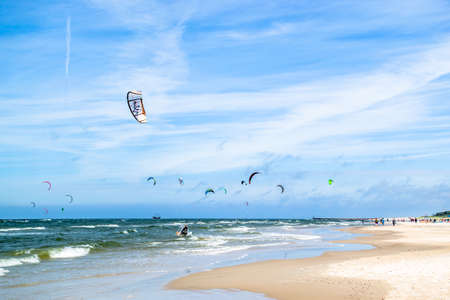 LEBA, POLAND - JULY 09, 2016: Kitesurfers on the Leba beach in Poland. Polish sea coast is popular place for extreme water sport like kitesurfing.のeditorial素材
