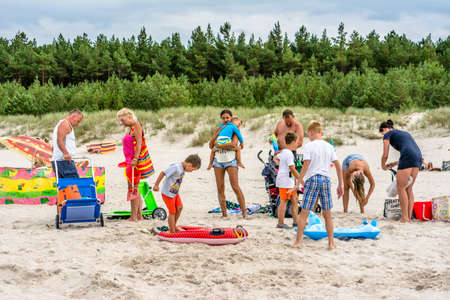 LEBA, POLAND - JULY 31, 2016: Big family on the beach in the summer over sea, relax and leisure timeのeditorial素材