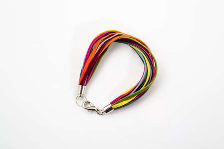 Macro of handmade bracelet made with colorful leather straps isolated on white background, top view.の写真素材
