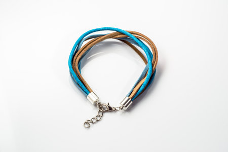 Macro of handmade bracelet made with colorful leather straps isolated on white background.の写真素材