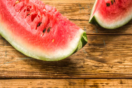 Slices of watermelon, background. Summer fruit on wooden planks background, close-up.の写真素材