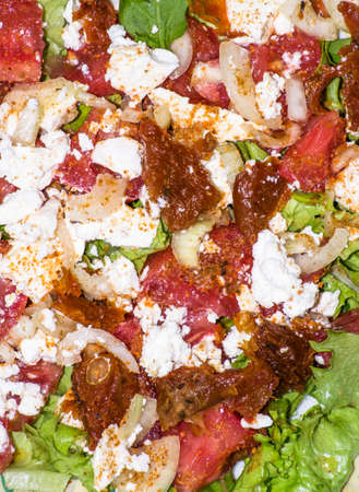 Salad with vegetables with feta cheese and sun-dried tomatoes, macro close-up, food backgroundsの写真素材