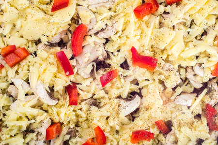 Close-up of homemade pizza with cheese, mushrooms champignons and paprika. Food background, top view.の写真素材