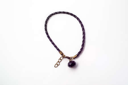 Close-up of handmade bracelet made with black leather and black crystal glass isolated on white background, fashionable simple made, top view.の写真素材