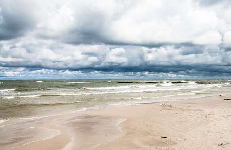 Landscape of sea with waves and cloudy sky. Baltic sea coast near Leba in Poland.の写真素材
