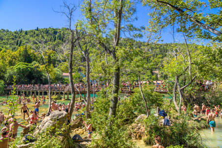 KRKA NATIONAL PARK, CROATIA - AUG 19, 2019: People swim in Krka River in Croatia, travel, tourism and active vacation concept.のeditorial素材