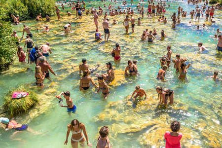 KRKA NATIONAL PARK, CROATIA - AUG 19, 2019: People swim in Krka River in Croatia, travel, tourism and active vacation concept.のeditorial素材