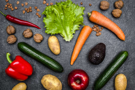 Healthy food background. Healthy vegetarian food. Vegetables and fruits on black stone. Clean vegetarian eating concept.の写真素材