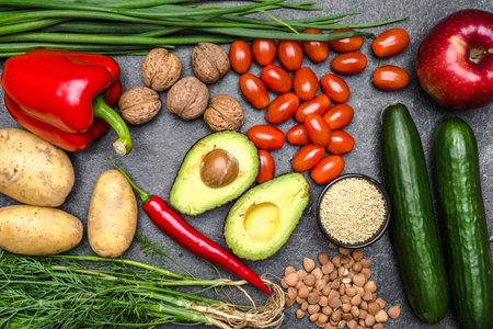 Healthy food background. Healthy vegetarian food. Vegetables and fruits on black stone. Clean vegetarian eating concept.の写真素材