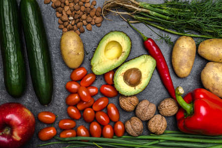 Healthy food background. Healthy vegetarian food. Vegetables and fruits on black stone. Clean vegetarian eating concept.の写真素材