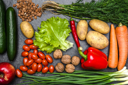 Healthy food background. Healthy vegetarian food. Vegetables and fruits on black stone. Clean vegetarian eating concept.の写真素材