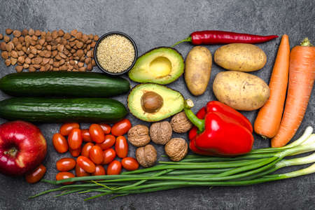 Healthy food background. Healthy vegetarian food. Vegetables and fruits on black stone. Clean vegetarian eating concept.の写真素材