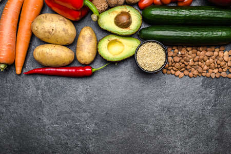 Healthy food background. Healthy vegetarian food. Vegetables and fruits on black stone. Clean vegetarian eating concept.の写真素材