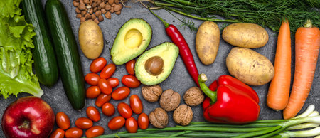Healthy food background. Healthy vegetarian food. Vegetables and fruits on black stone. Clean vegetarian eating concept.の写真素材