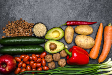 Healthy food background. Healthy vegetarian food. Vegetables and fruits on black stone. Clean vegetarian eating concept.の写真素材